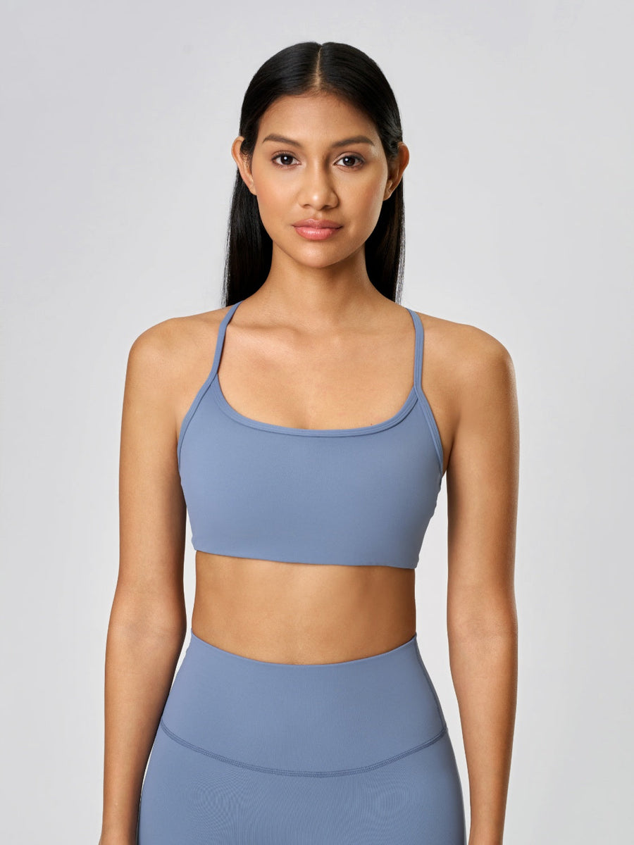 Strappy back active crop top in Dusty Blue with a scoop neckline.
