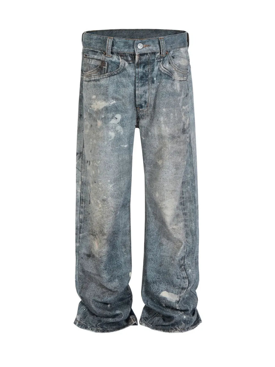 Artisan distressed wide-leg jeans in medium wash denim with paint splatters.