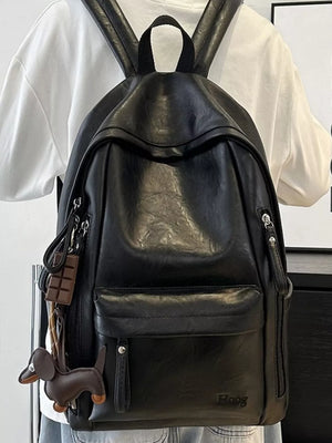 Chic black pu leather medium backpack with dog and chocolate bar charms.