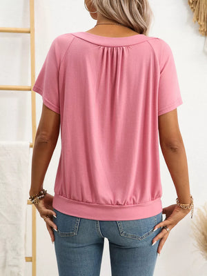 Pink ruched V-neck t-shirt with short sleeves and banded hem.