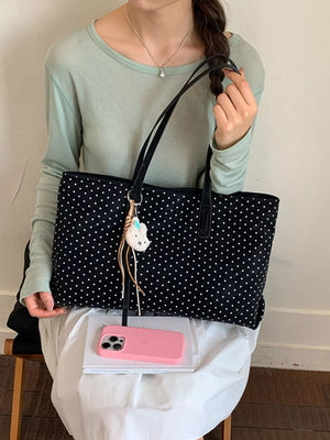 handbag in black featuring shoulder straps and boxy fit