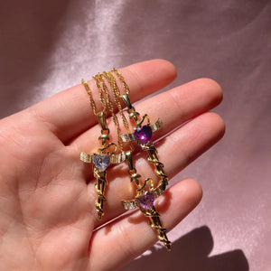 Gold plated necklaces with heart-shaped crystal cross charms and wing details