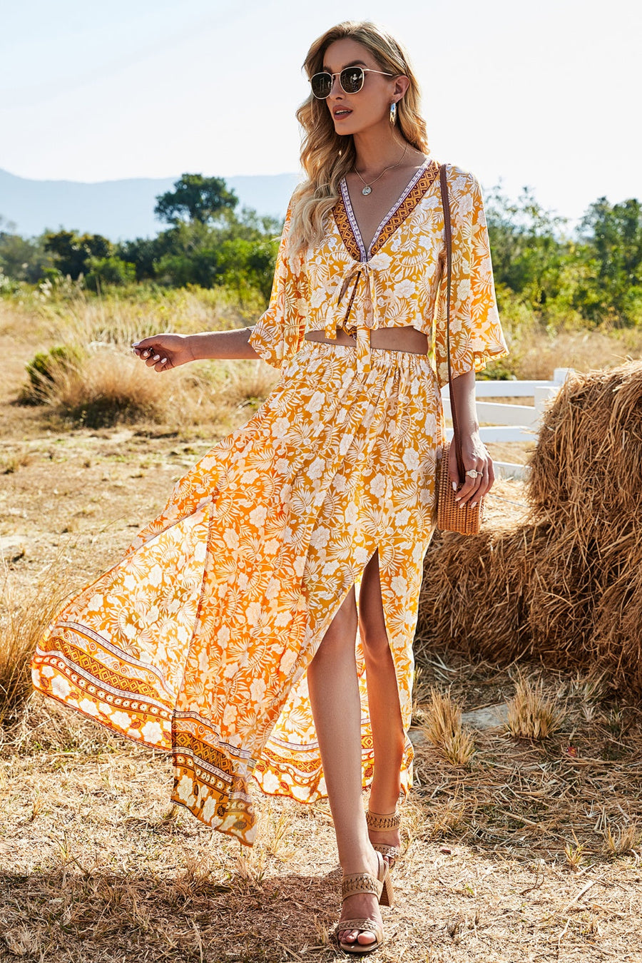 Bohemian floral crop top and maxi skirt set in tangerine with tie-front, V-neck, and high-slit skirt.