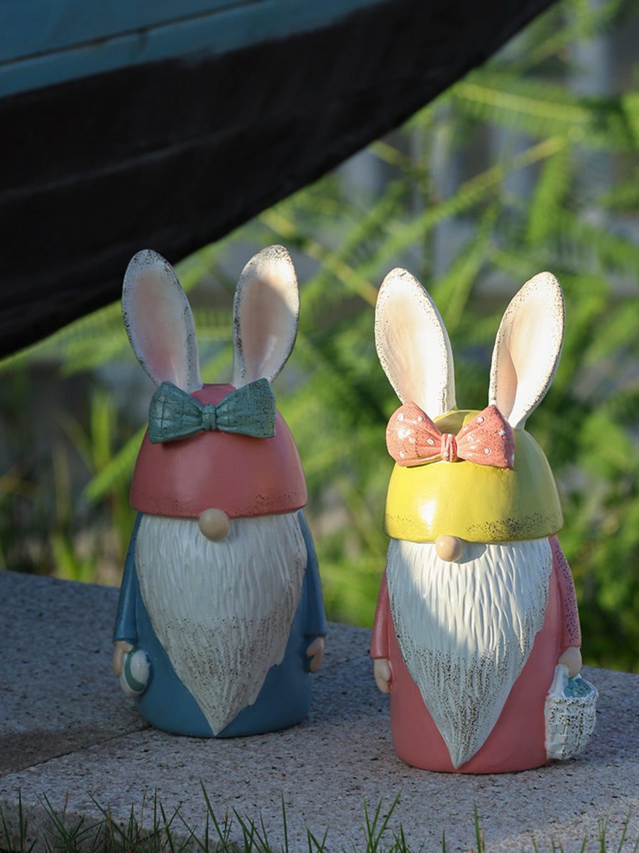Easter bunny gnomes in pastel blue and blush pink, with white beards and bow ties.