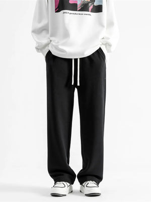 Black relaxed fit drawstring wide-leg sweatpants with white drawstrings.