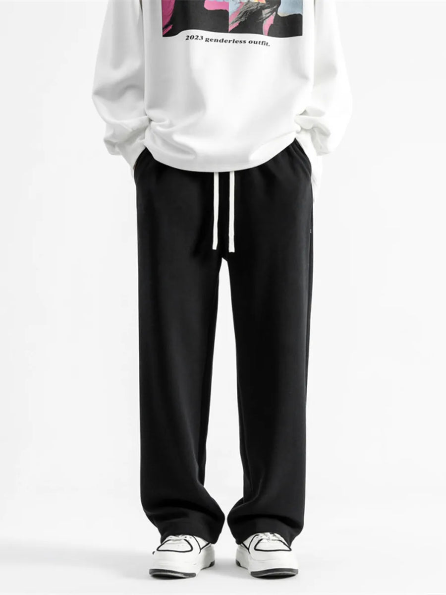 Black relaxed fit drawstring wide-leg sweatpants with white drawstrings.