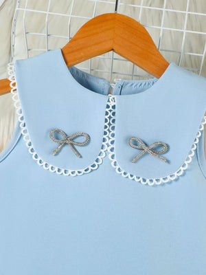 Blue toddler dress with Peter Pan collar, lace trim, and two sparkly bow details.