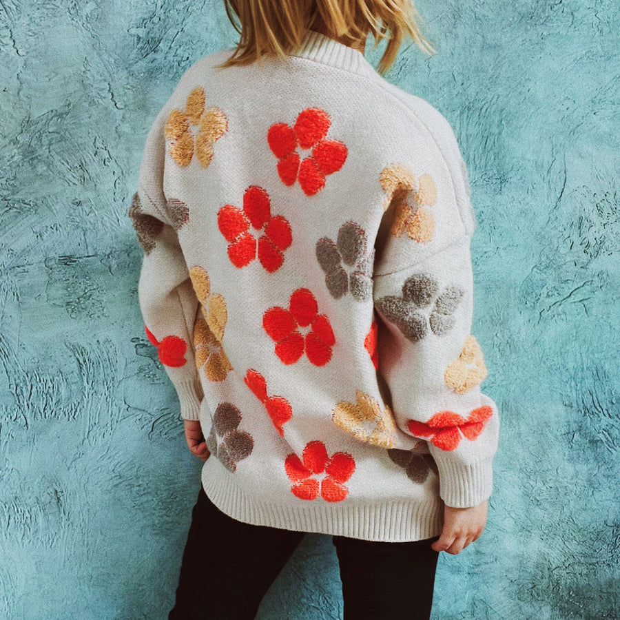 Ivory knit cardigan with embroidered floral pattern, crew neck, and long sleeves.