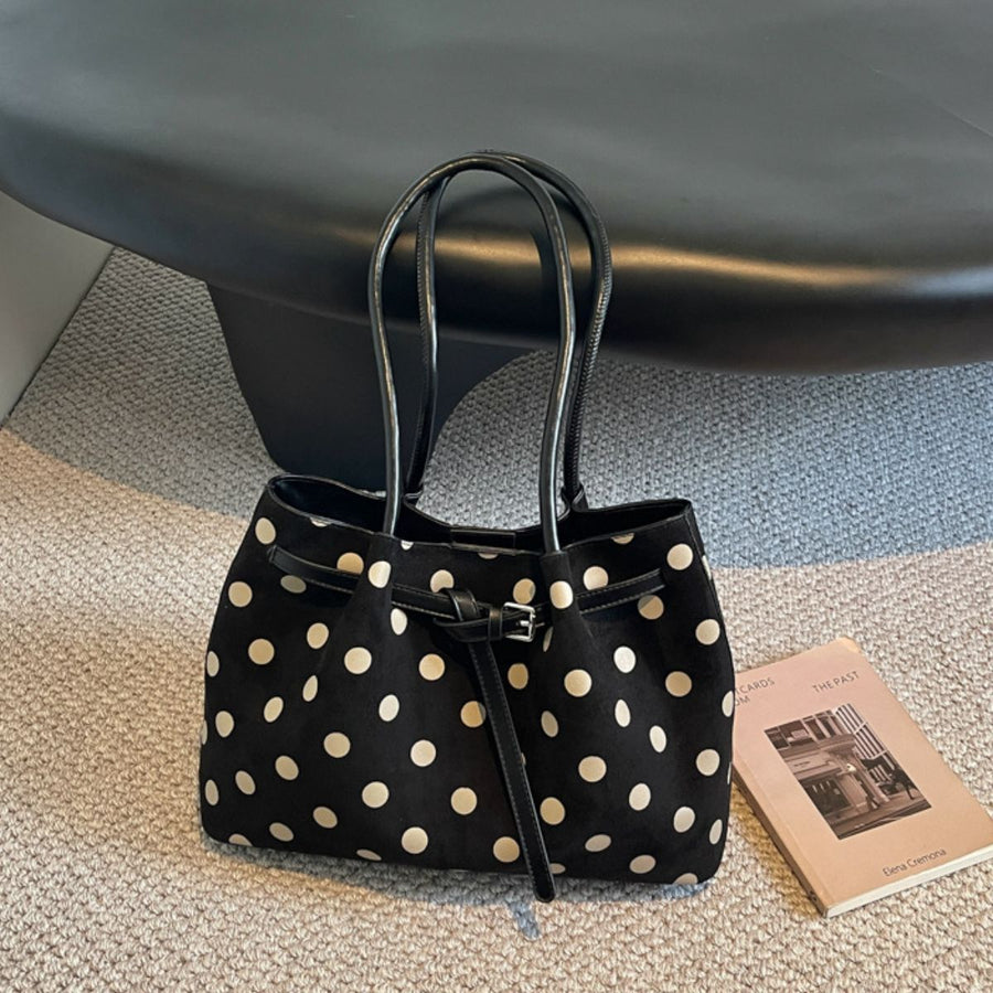 shoulder bag in black featuring shoulder strap and structured fit