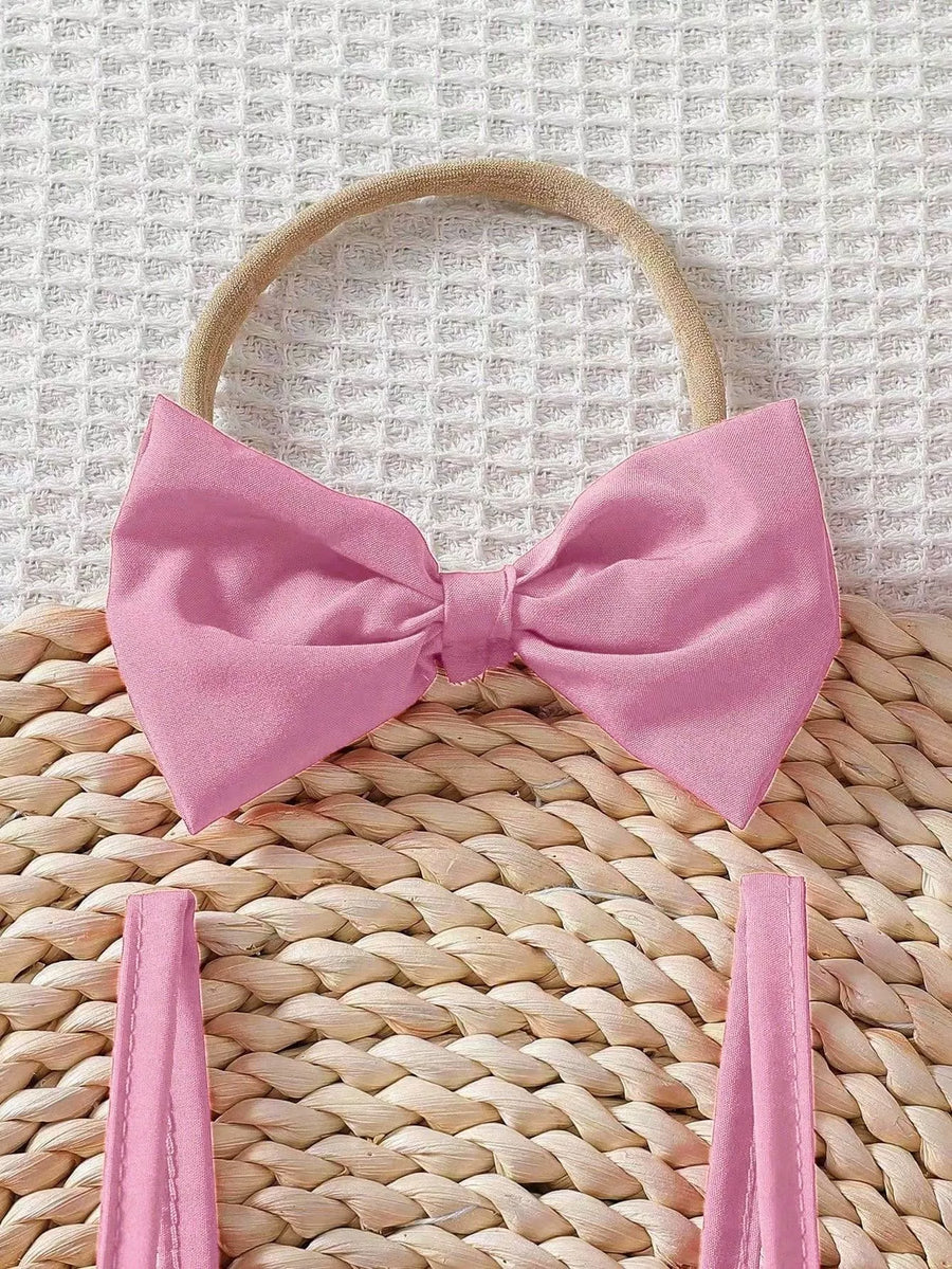 Baby pink cotton bow headband and matching ruffle top straps.