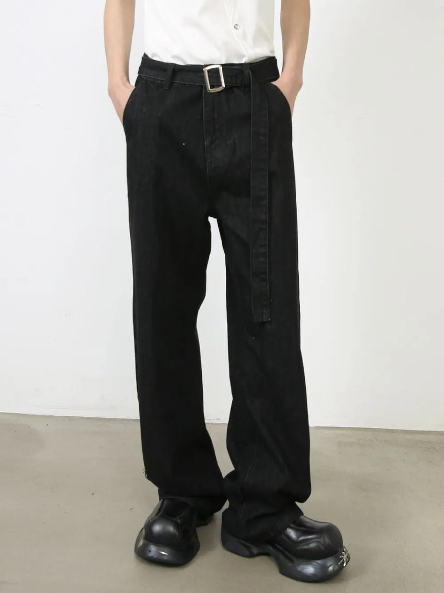 Black denim wide-leg trousers with a matching belt and silver buckle.