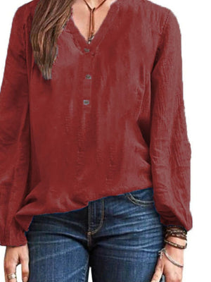 Burgundy long-sleeve blouse with V-neck and button detail