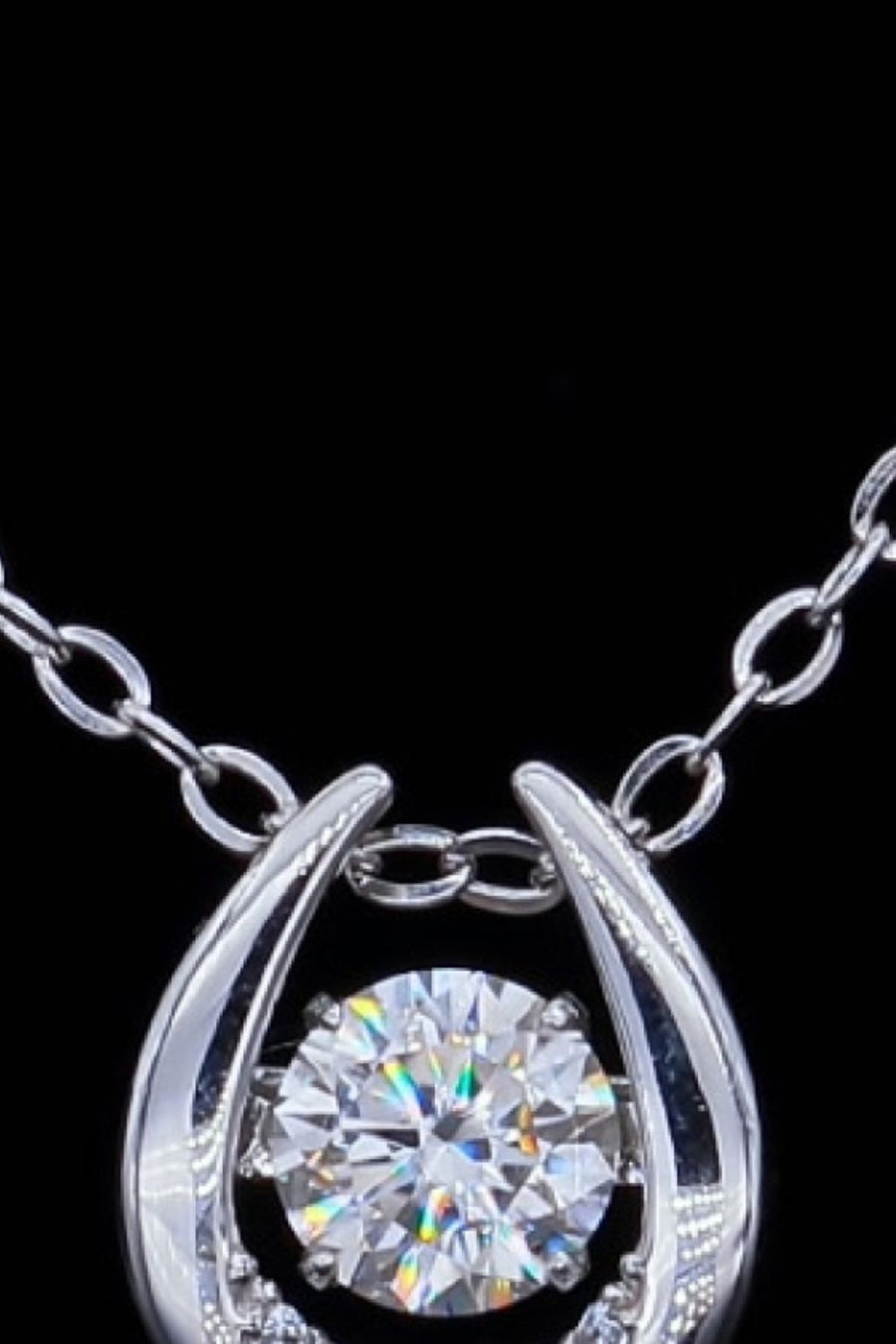 Silver necklace with a round brilliant cut diamond in a halo setting.