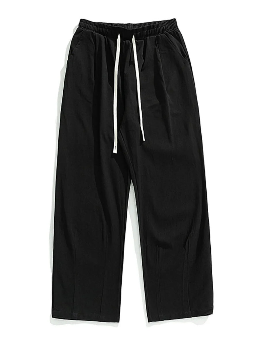 Black wide-leg pleated trousers with drawstring and front pleats