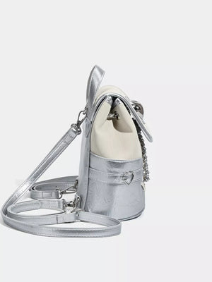 Charming mini heart flap backpack in silver with a white top and chain detail.