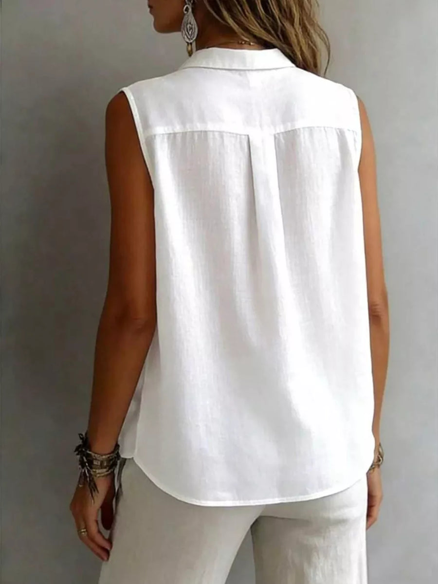 White sleeveless button-up shirt with collar and back pleats.