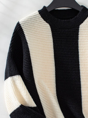 Colorblock stripe knit sweater in black and cream with waffle texture and crew neck.