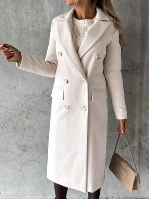 Chic double-breasted longline trench coat in apricot with button details.