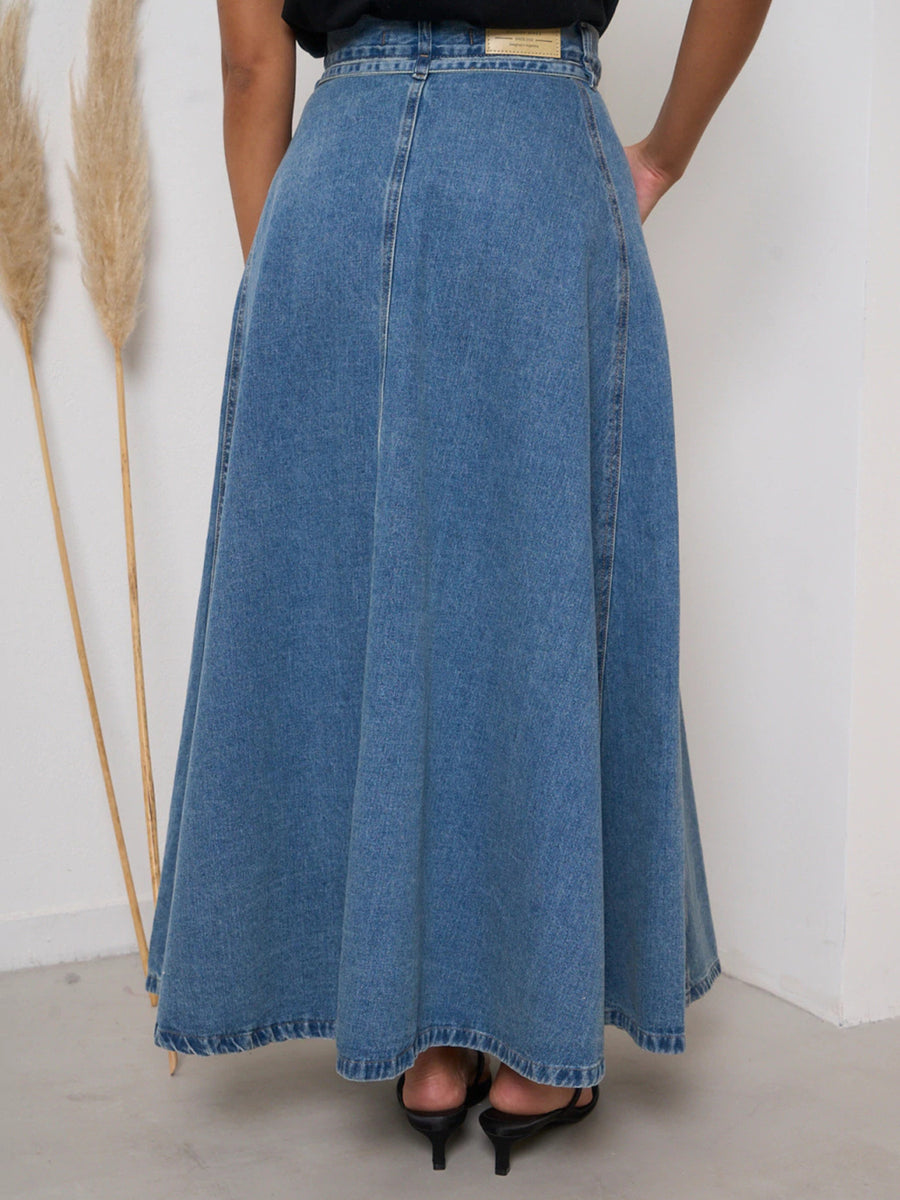 High-waisted A-line denim skirt in Dusty Blue, with a full, flowing cut.