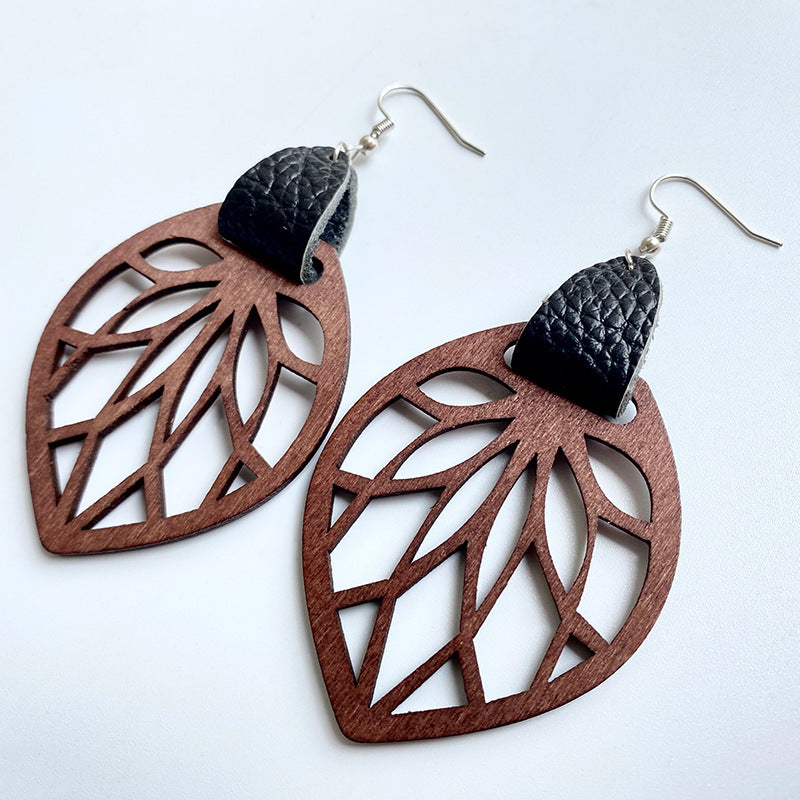 Brown wood leaf cutout dangle earrings with black leather accent.