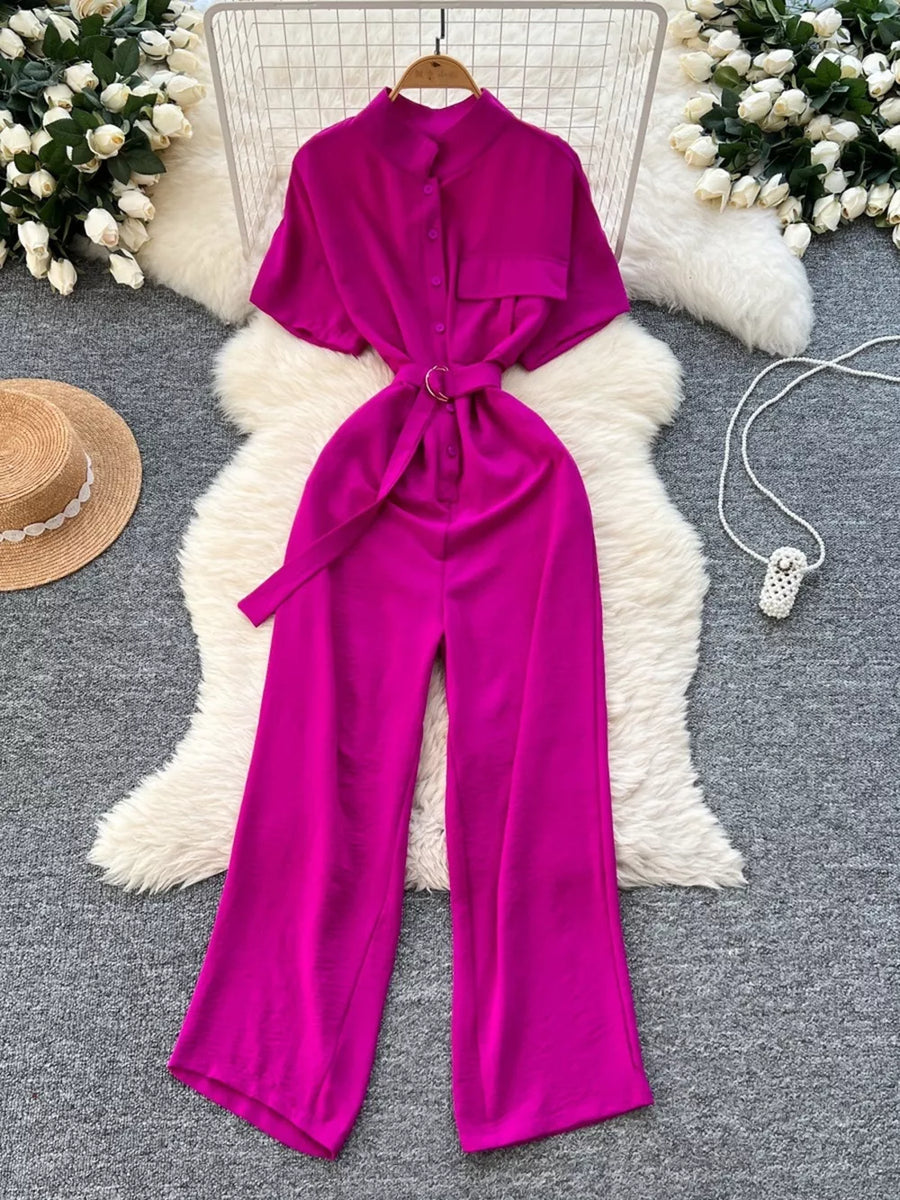 Rose red belted wide leg romper with short sleeves and a button-down front.