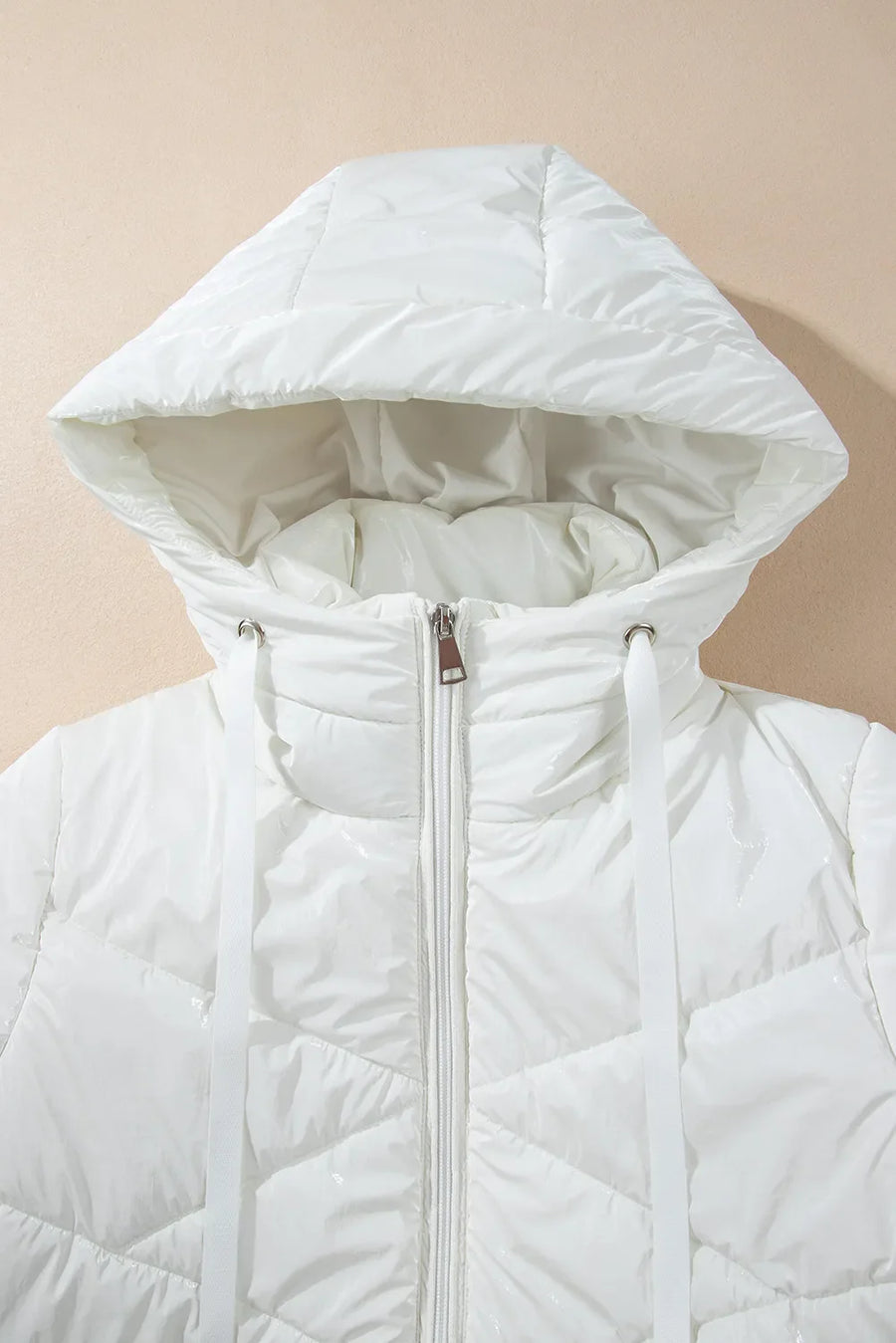 White glossy quilted hooded puffer jacket with a zipper and drawstring hood.