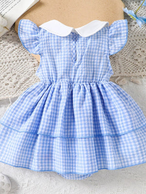 Pastel blue gingham baby dress with ruffled sleeves and tiered skirt.