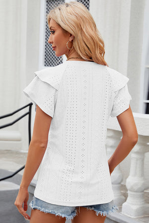 White eyelet flutter sleeve blouse with ruffled shoulders and short sleeves.