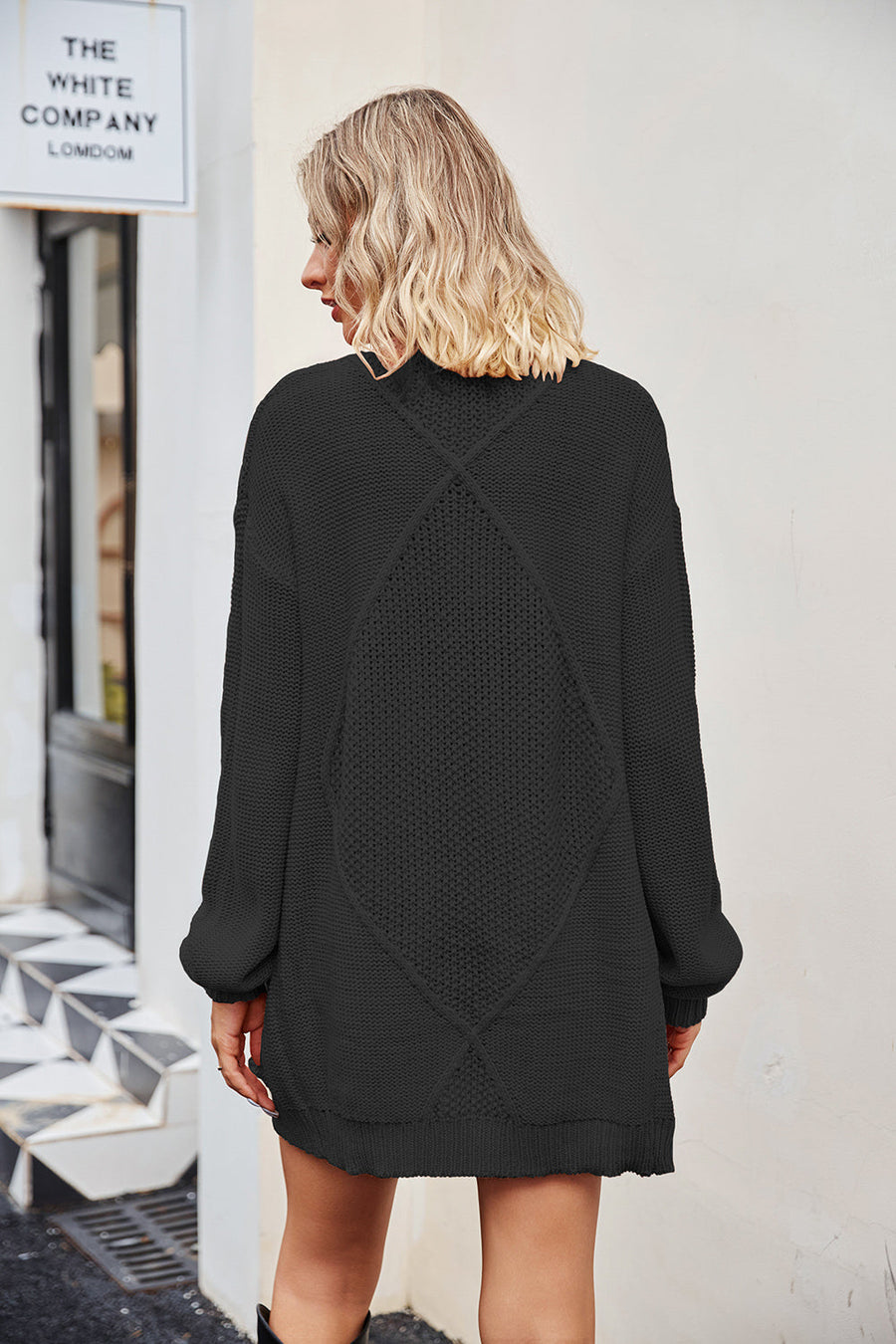 Black cable knit cardigan with diamond pattern detail on back, acrylic.