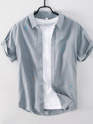 button-up shirt in sage green with paint splatter and buttoned