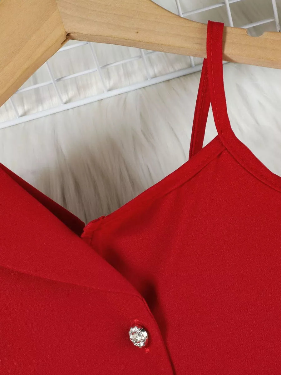 Red asymmetrical skirtini with spaghetti straps and rhinestone button detail.