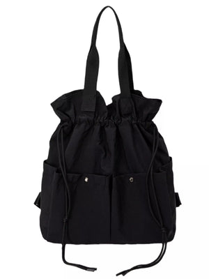 Black drawstring backpack with multiple exterior pockets and shoulder straps.