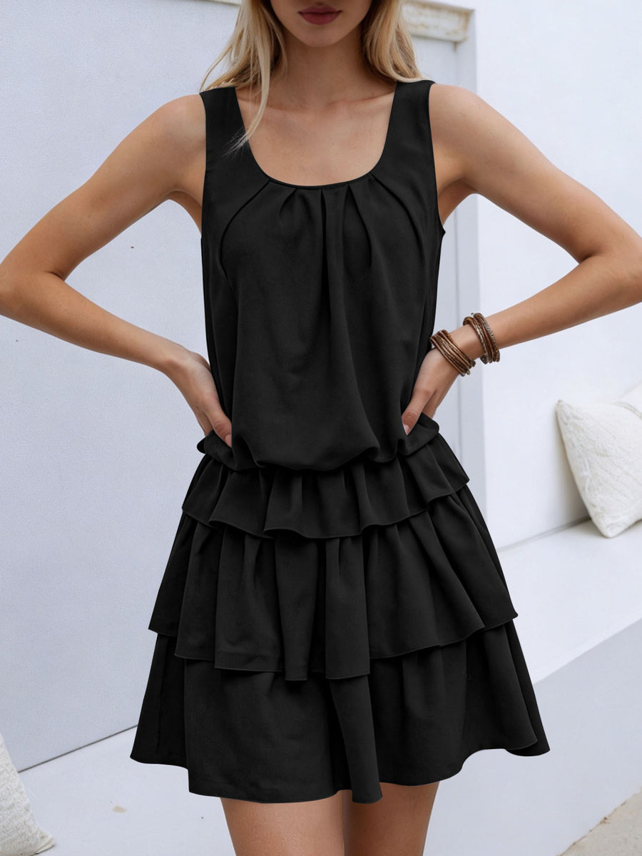 Black ruffled tiered mini dress with a gathered neckline and elastane.