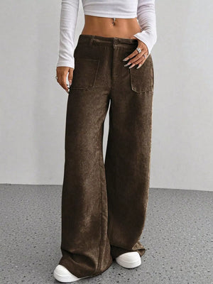 Brown corduroy wide-leg trousers with front pockets and a relaxed fit.