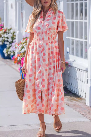 Charming puff sleeve midi dress in white with pink polka dots, smocked waist, and zip front.