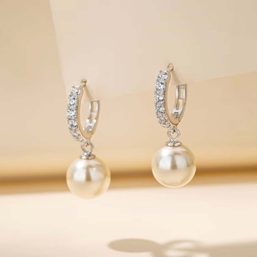 Elegant pearl drop hoop earrings with crystal accents.
