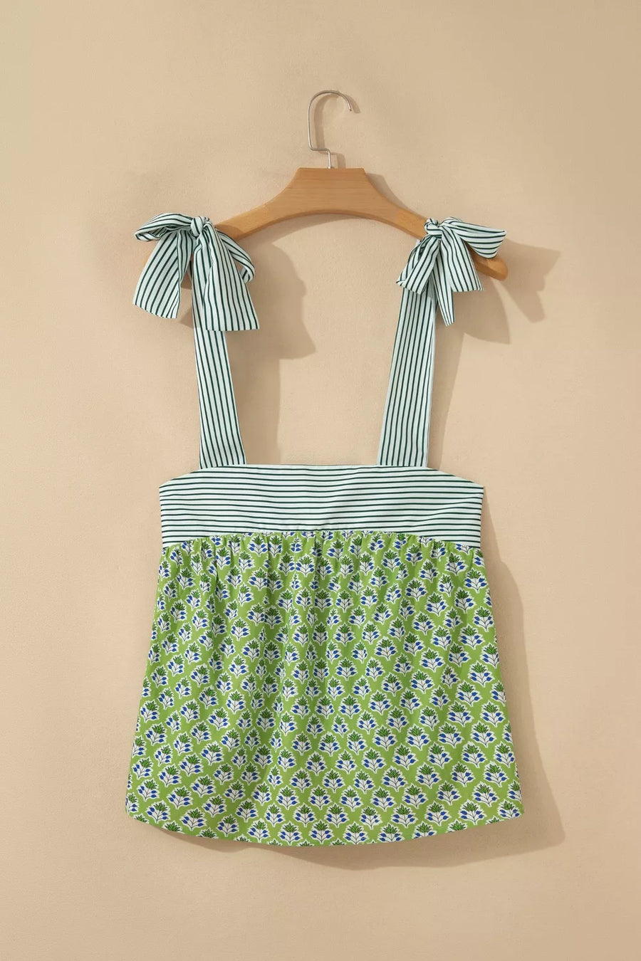 Floral tie-strap tank top with square neckline and green floral print.