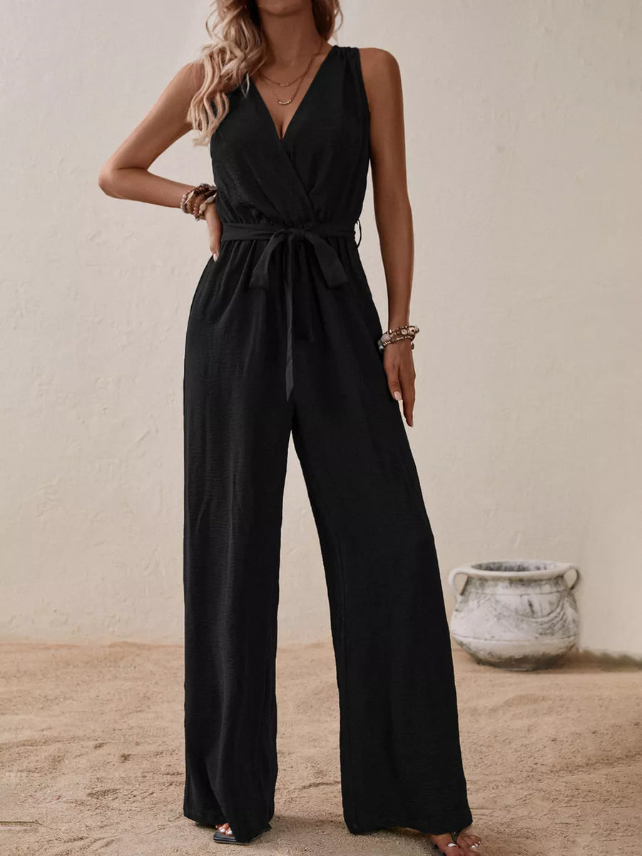 Black V-neck tie-waist wide-leg romper with sleeveless design and textured fabric.