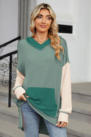 Colorblock green and beige waffle knit hoodie with long sleeves and a front pocket