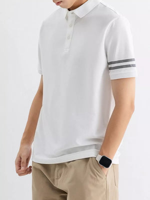 White cotton polo shirt with grey striped sleeves and a classic collar.