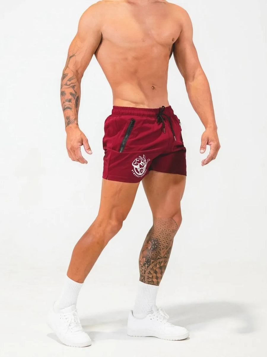Deep Red athletic shorts with drawstring and zippered pockets, featuring a white logo.