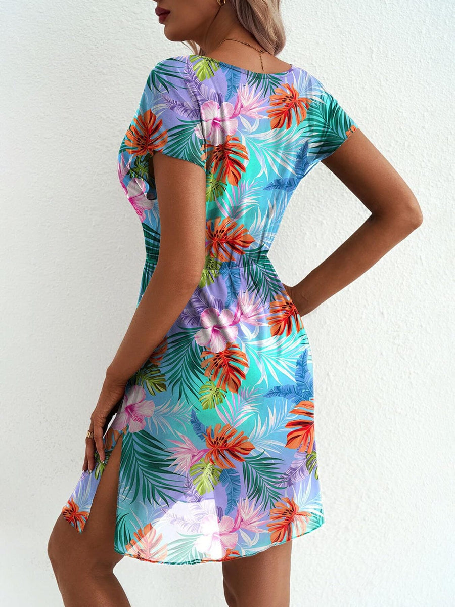 Vibrant leaf print mini dress in sky blue with short sleeves and a high slit.