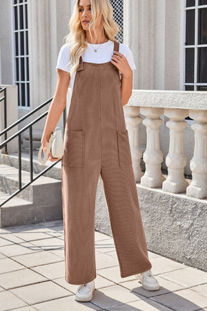 Caramel striped denim overalls with patch pockets and wide legs, worn with a white tee.