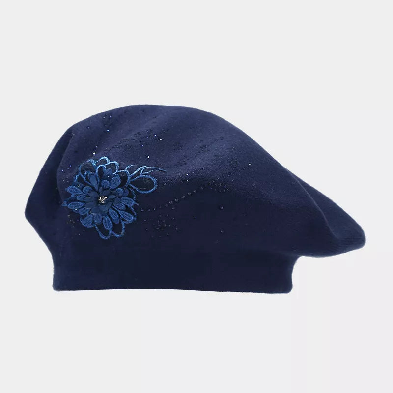 Black hat featuring rhinestone embellishment and floral