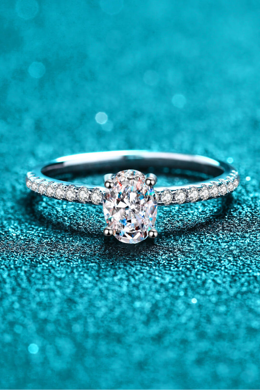 Silver oval moissanite ring with pavé band
