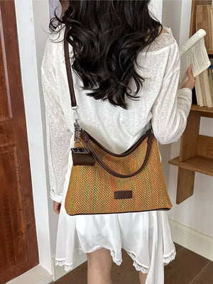 crossbody bag in orange featuring woven and relaxed fit