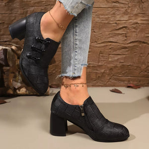 Black woven button-detail high heels with side zipper and block heel.