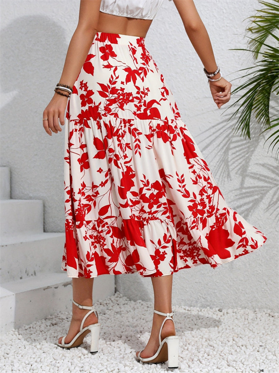 Crimson floral tiered midi skirt with ruffled hem, worn with white sandals.