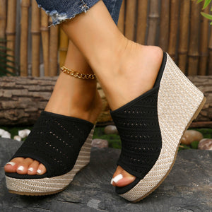 Black perforated espadrille wedge sandals with woven jute detail.