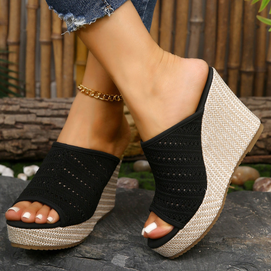 Black perforated espadrille wedge sandals with woven jute detail.